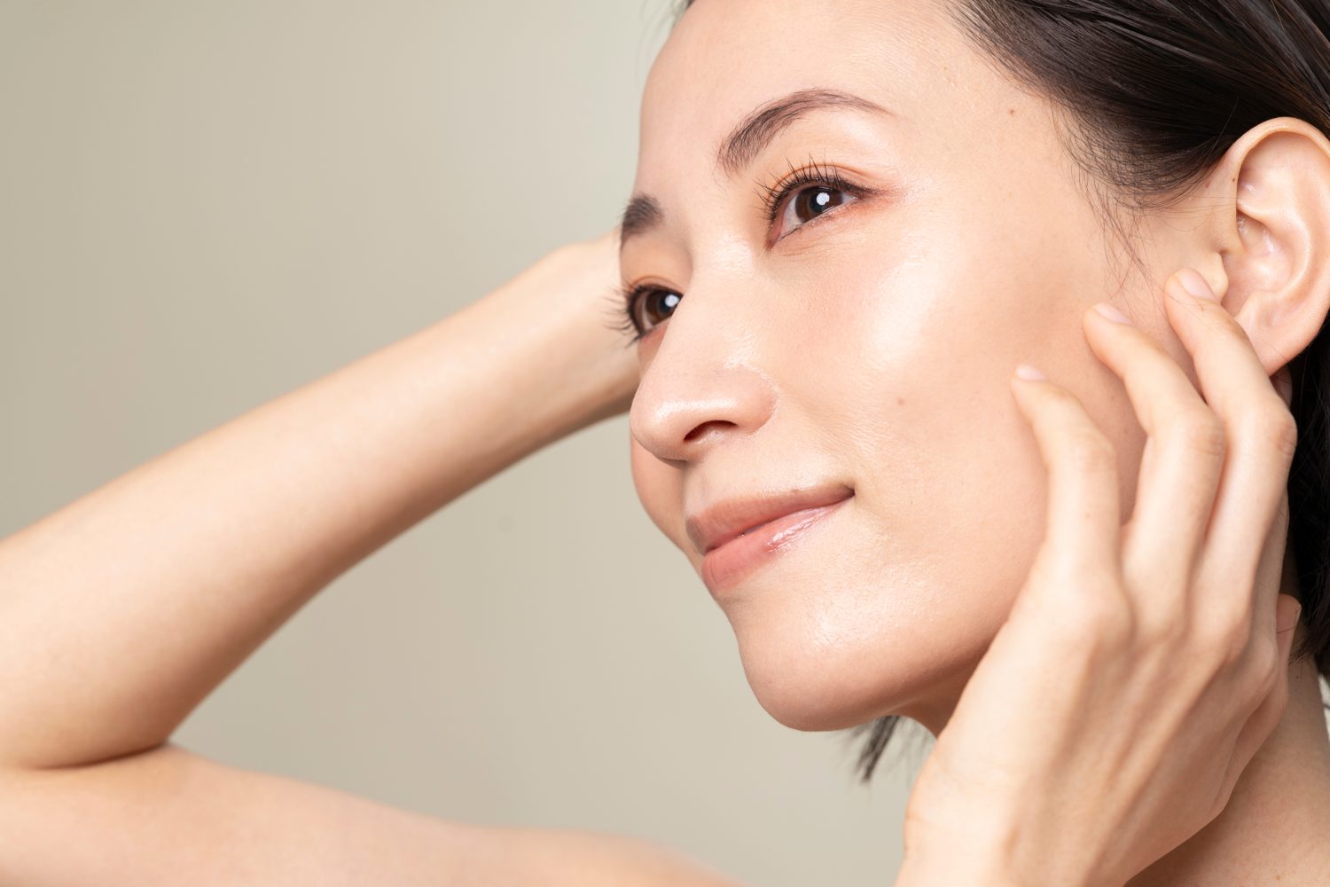 Woman touching her cheek to show facial skin quality