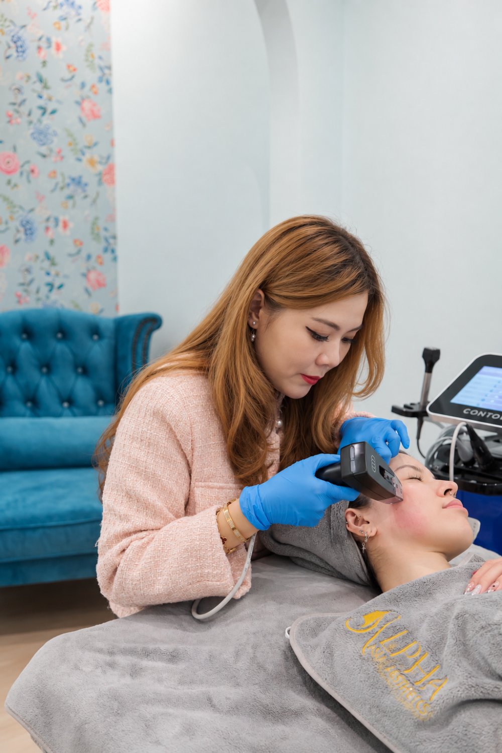 Practitioner performing an RF Gold Microneedling treatment on a patient's face
