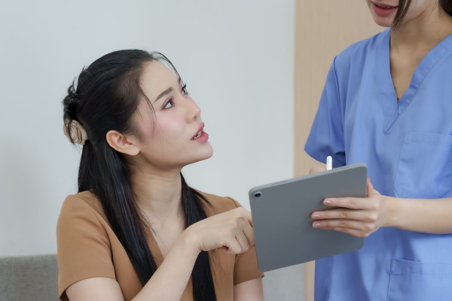 Patient discussing a treatment plan with a clinician on a tablet